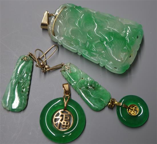 A carved jade pendant of tapered rectangular form, a similar pair of earrings and two jade bi-disc pendants